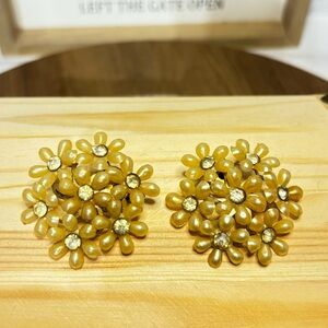 Vintage clip on earrings, cream colored and flower shaped, early plastics.